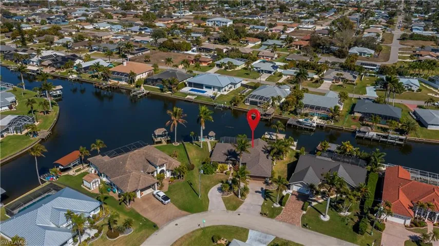 Aerial view of property and surrounding area with nearby suburban area and a nearby body of water