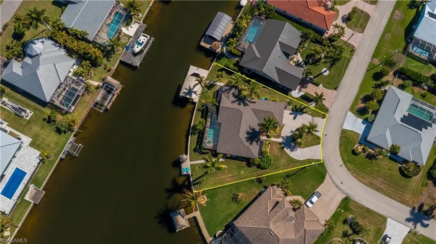 Aerial view of residential area featuring a large body of water