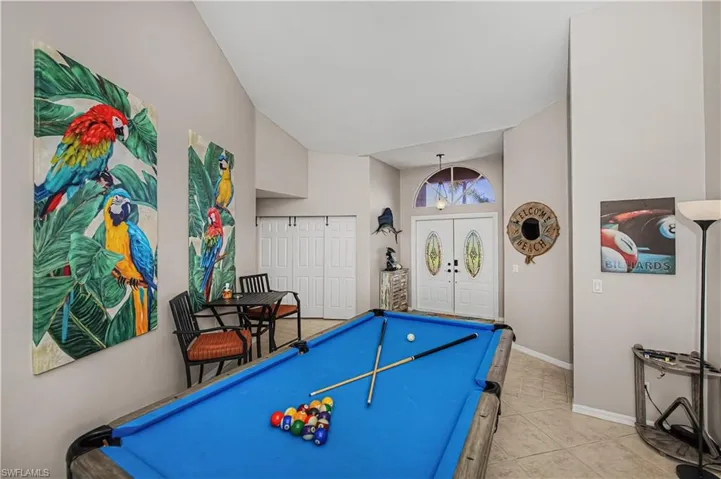 Recreation room featuring pool table, a high ceiling, and light tile patterned floors