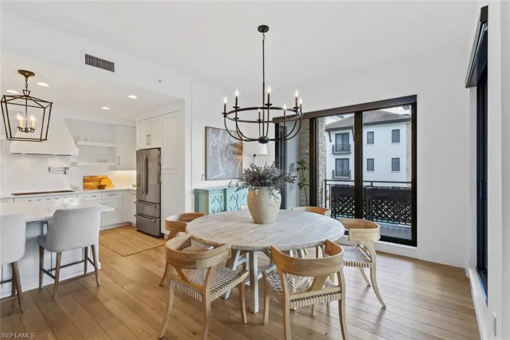 Dining space with a chandelier, light wood-style flooring, and recessed lighting