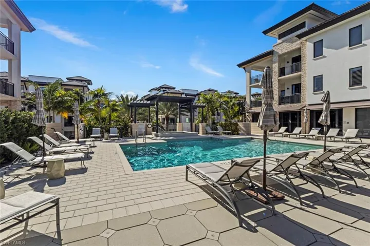 Community pool with a patio and a balcony