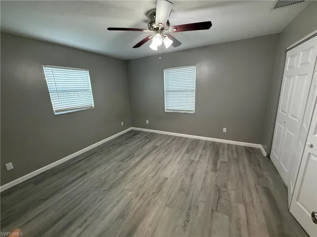 Unfurnished bedroom with a closet, a ceiling fan, and light wood-style flooring