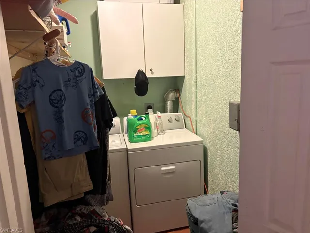 Laundry area with washer and clothes dryer and cabinet space