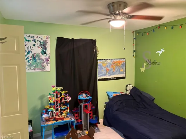 Bedroom with ceiling fan and baseboards