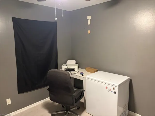 Office space featuring a ceiling fan and light wood-style floors