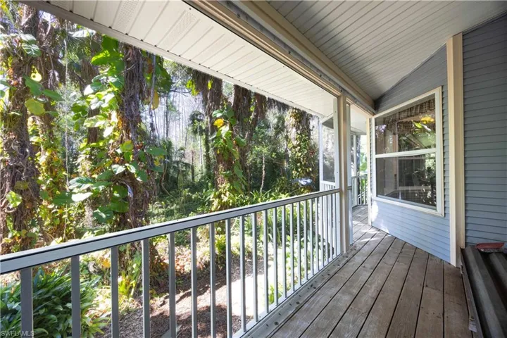 Wooden terrace featuring a sunroom
