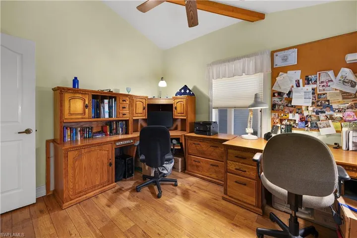 Office with lofted ceiling with beams, light wood-style flooring, and ceiling fan