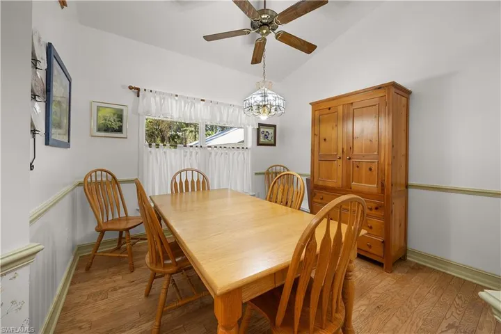 Dining area featuring light wood-type flooring, lofted ceiling, and hanging lights