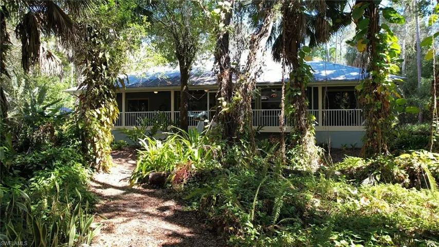 Rear view of house featuring a sunroom