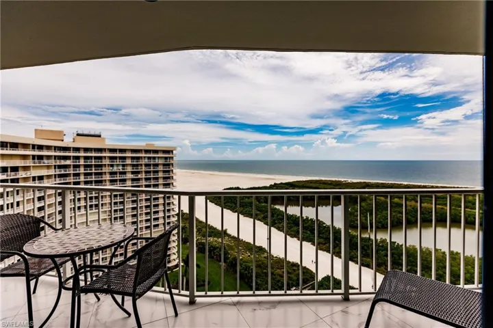 Balcony featuring view of water and beach
