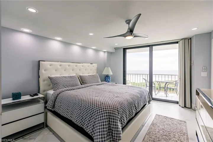 Bedroom with floor to ceiling windows, a water view, access to outside, recessed lighting, and ceiling fan