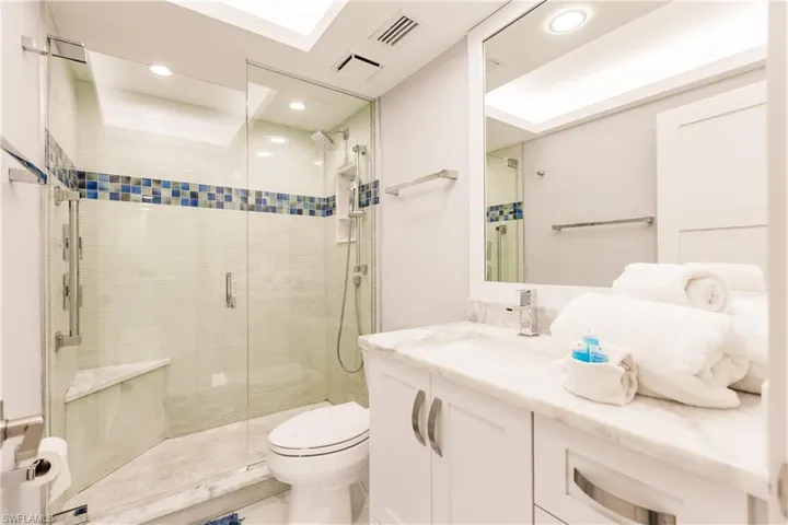 Full bath with vanity, a stall shower, and recessed lighting