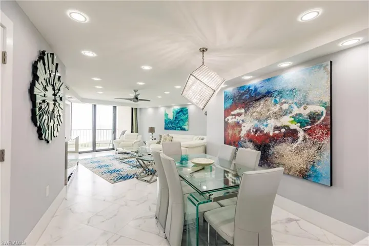 Dining room with recessed lighting, expansive windows, light marble finish flooring, and ceiling fan