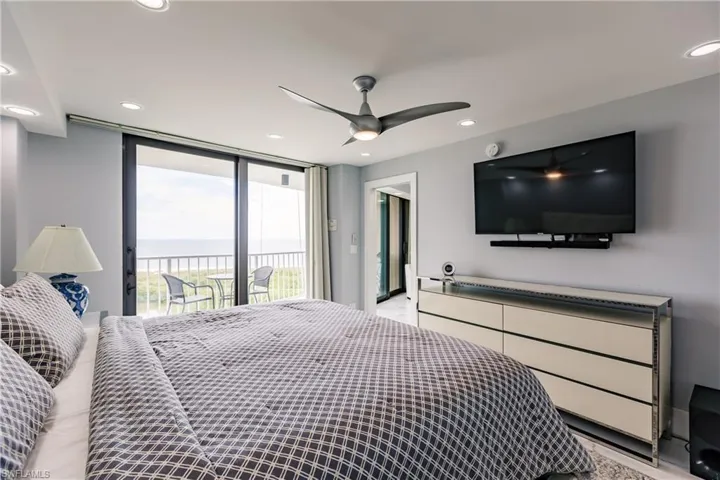 Bedroom with floor to ceiling windows, a ceiling fan, access to outside, and recessed lighting