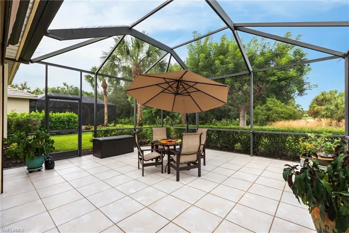 View of patio / terrace with a sunroom, glass enclosure, and outdoor dining area