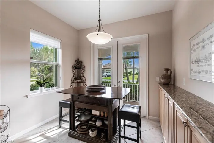 Dining room with light tile patterned flooring and baseboards