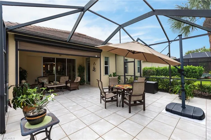View of patio featuring a sunroom, glass enclosure, an outdoor living space, and outdoor dining space