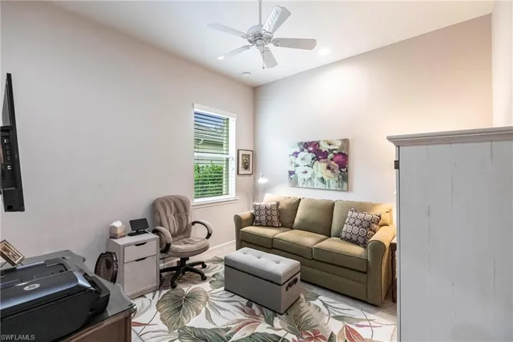 Living area featuring a ceiling fan and recessed lighting