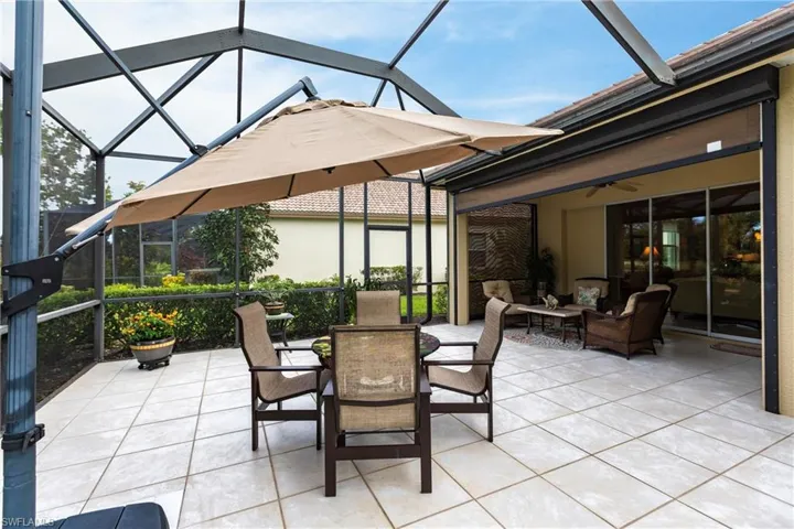 View of patio / terrace with glass enclosure, a sunroom, outdoor dining space, ceiling fan, and an outdoor hangout area