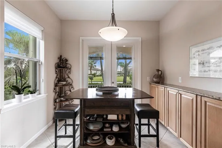 Dining room with light tile patterned floors and baseboards