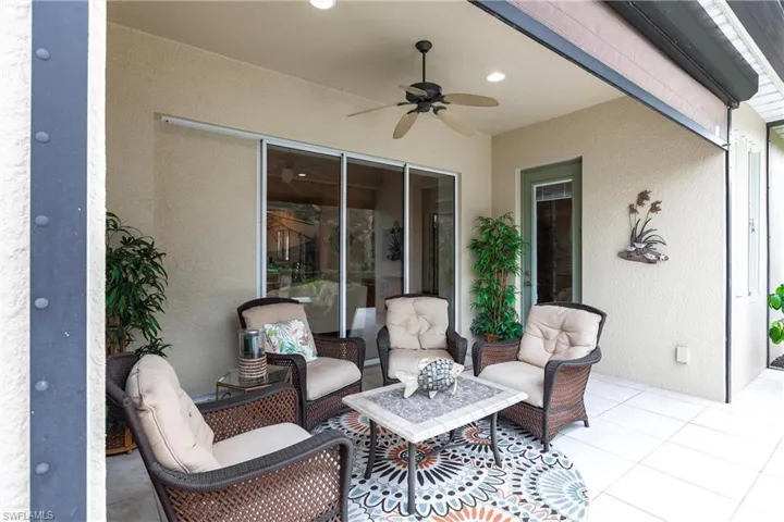 View of patio with a ceiling fan and an outdoor hangout area