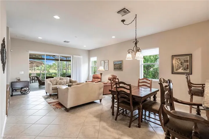 Dining area with recessed lighting and light tile patterned floors