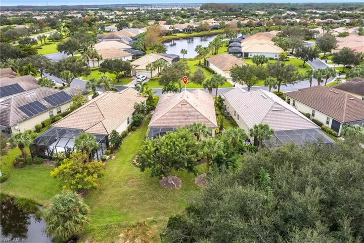 Aerial perspective of suburban area featuring a large body of water