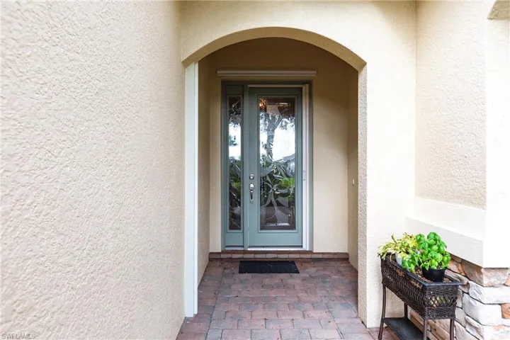 View of exterior entry featuring stucco siding