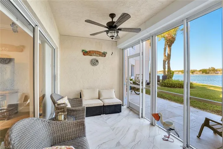 Lanai featuring water view and ceiling fan