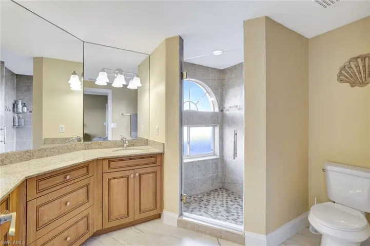Bathroom featuring vanity and a shower stall