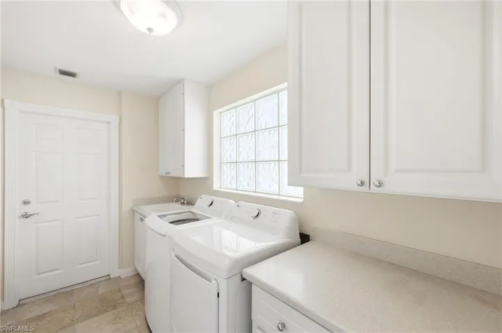 Laundry room featuring washing machine and dryer and cabinet space