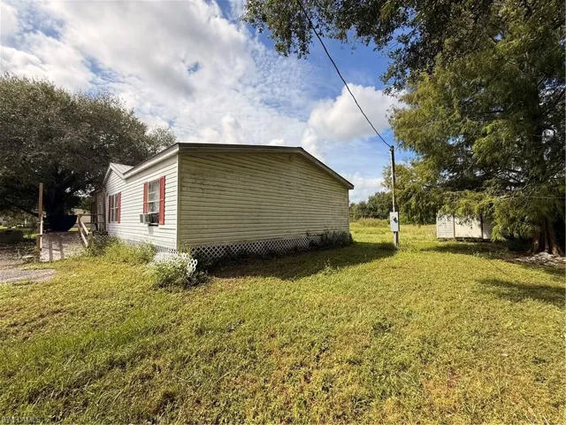 View of home's exterior with a yard