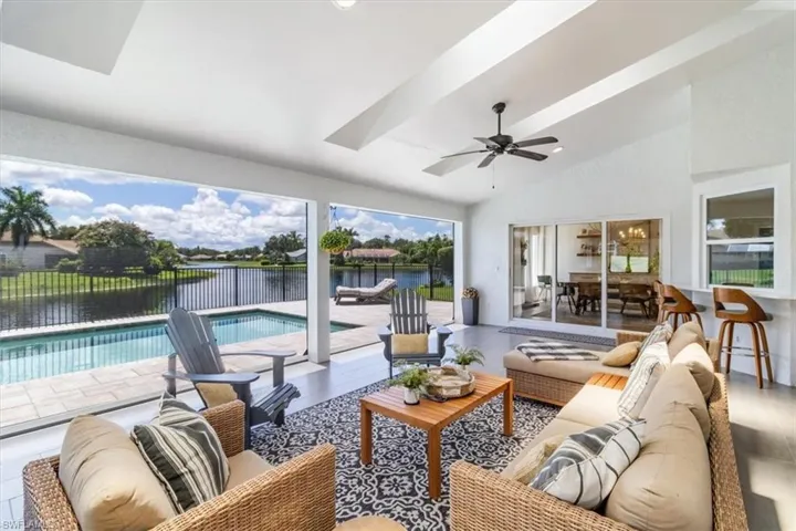 Large covered lanai with view of the pool and lake