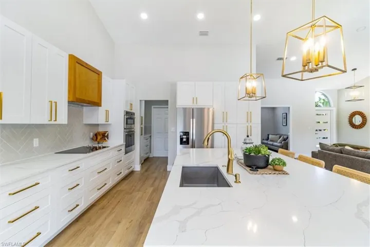 white quartz counters and new gold colored fixtures
