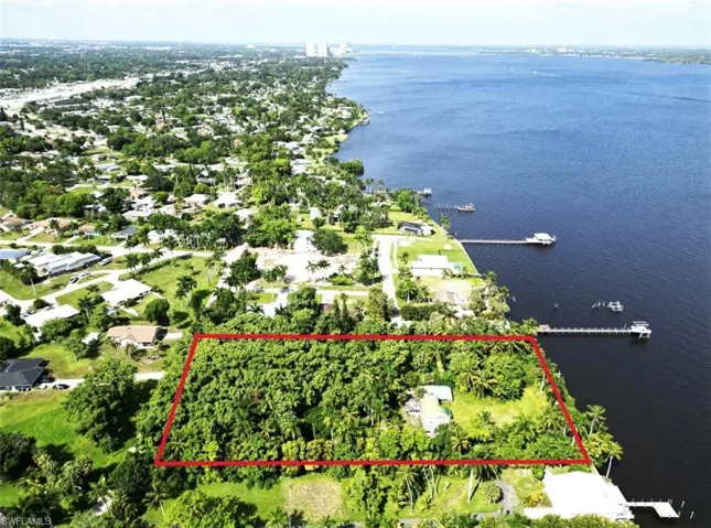 Birds eye view of property with a water view