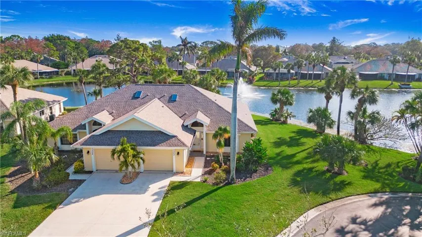 Birds eye view of property with a water view