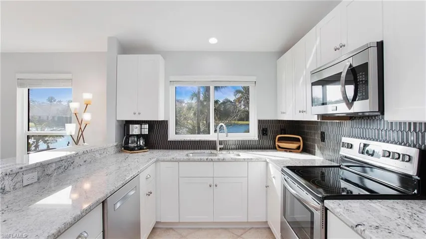 Kitchen featuring sink, appliances with stainless steel finishes, and a healthy amount of sunlight