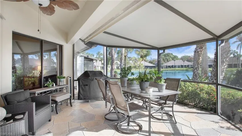 Sunroom / solarium featuring plenty of natural light, a water view, and ceiling fan