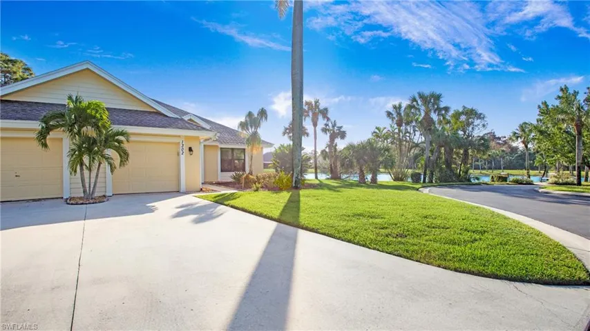 View of front of home with a front lawn and a garage