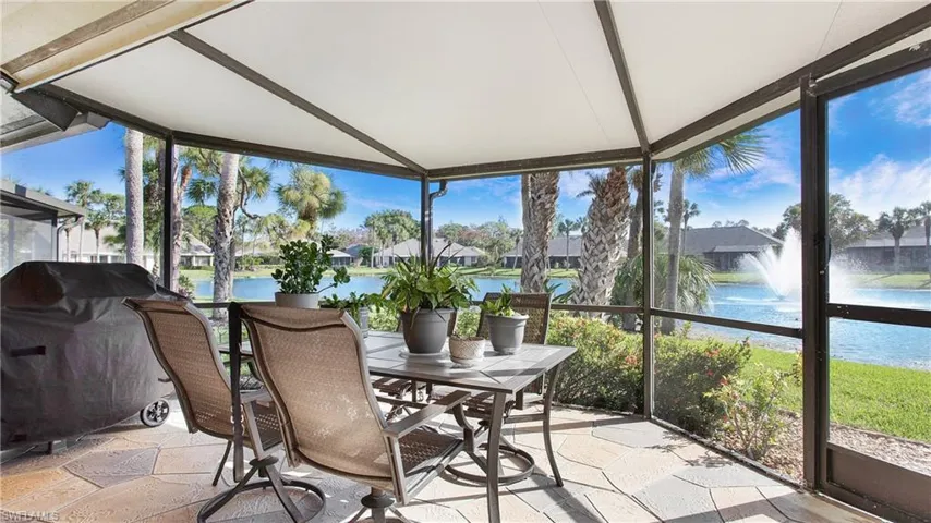 Sunroom / solarium featuring a water view and a wealth of natural light