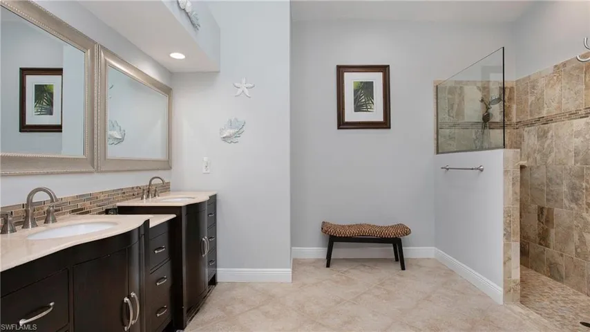 Bathroom with a tile shower and vanity