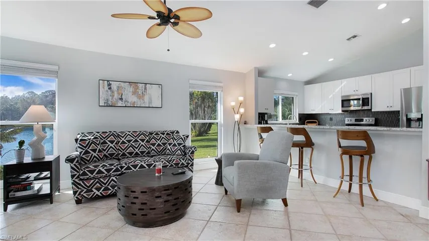 Living room with lofted ceiling, sink, and ceiling fan