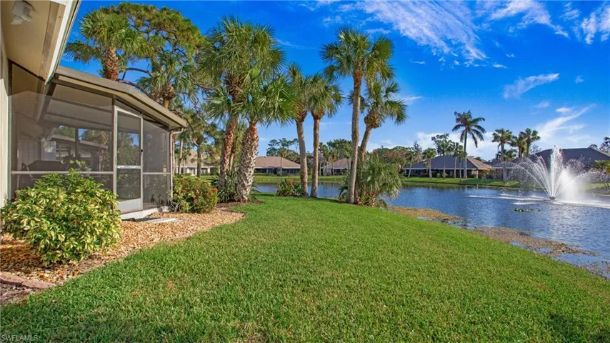View of yard with a water view and a sunroom