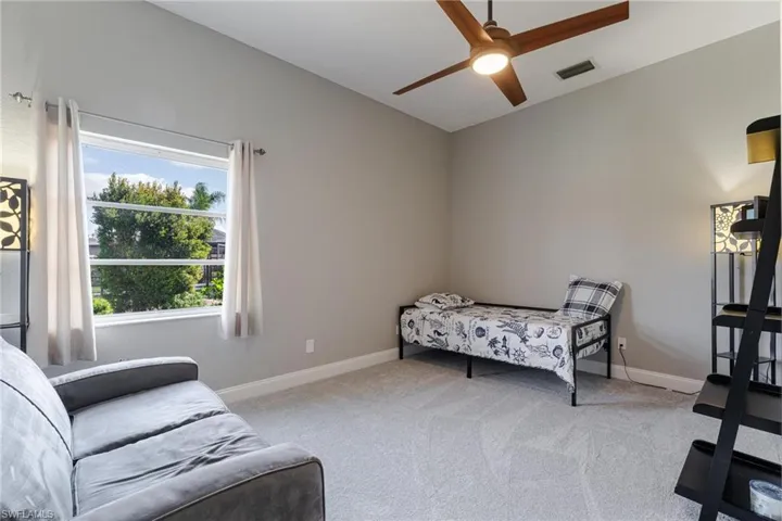 Carpeted bedroom with ceiling fan