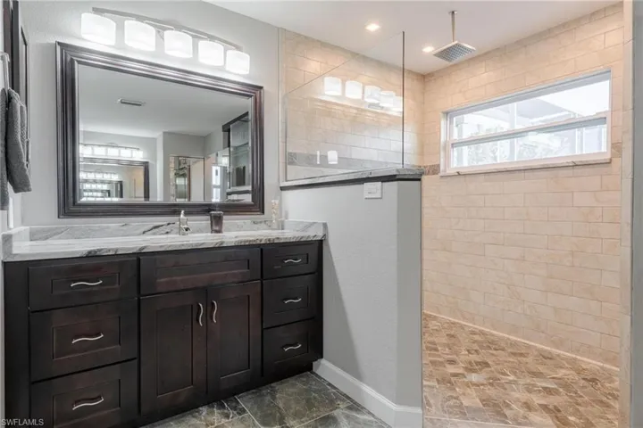Bathroom with tile patterned floors and vanity