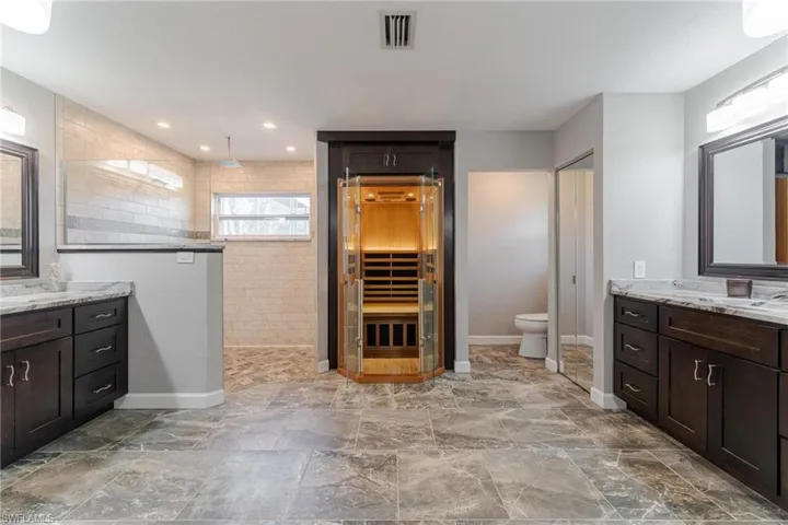 Bathroom with tile patterned floors, vanity, and toilet