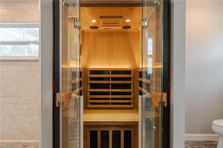 View of sauna featuring tile patterned flooring and wooden ceiling