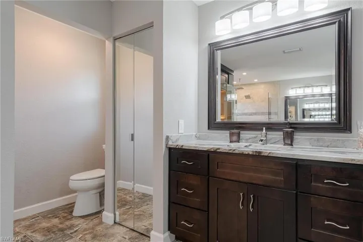 Bathroom featuring tile patterned floors, toilet, and vanity