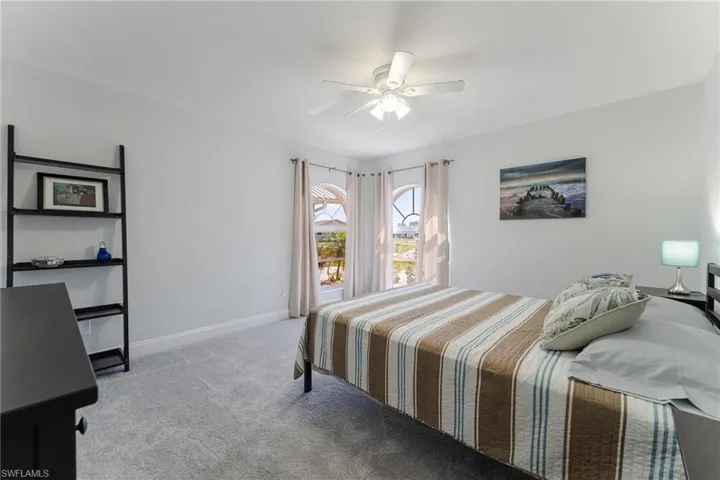 Carpeted bedroom with ceiling fan