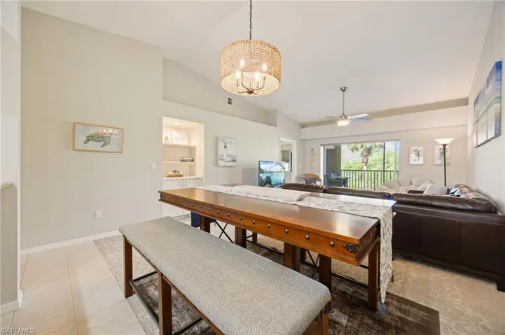 Dining space featuring suspended lighting, lofted ceiling, and ceiling fan